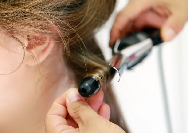 Curling hair with a curling iron